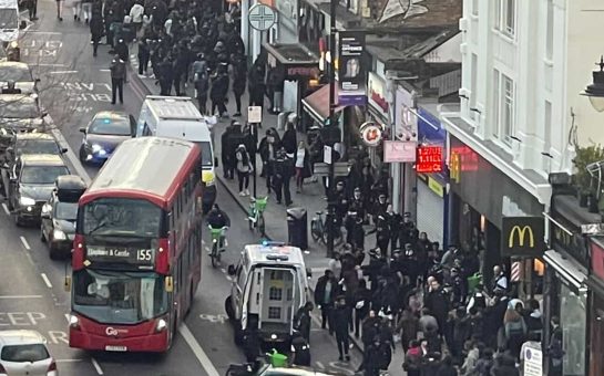 busy high street with lots of people and cars