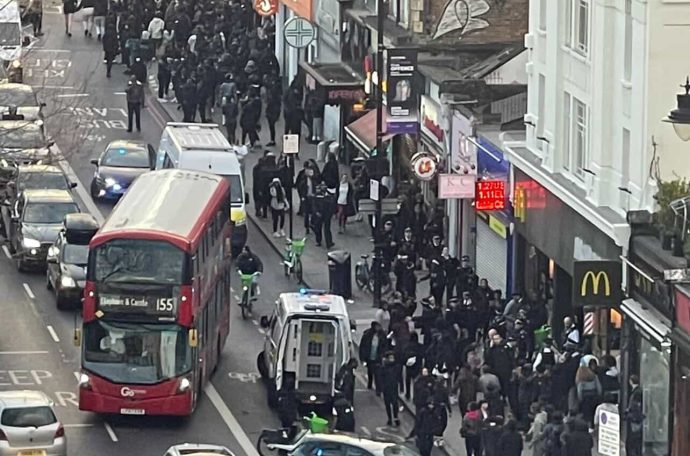 busy high street with lots of people and cars
