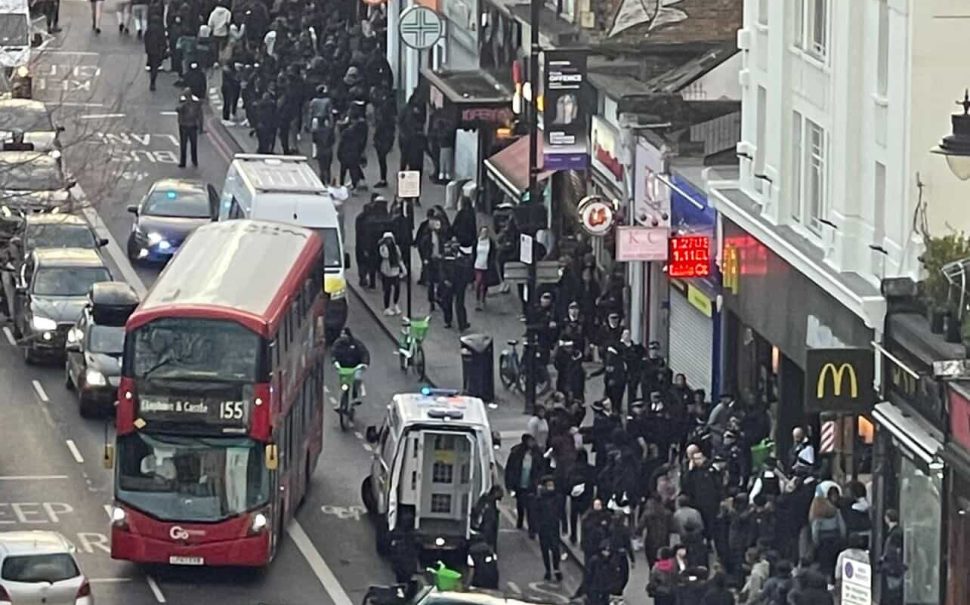 busy high street with lots of people and cars