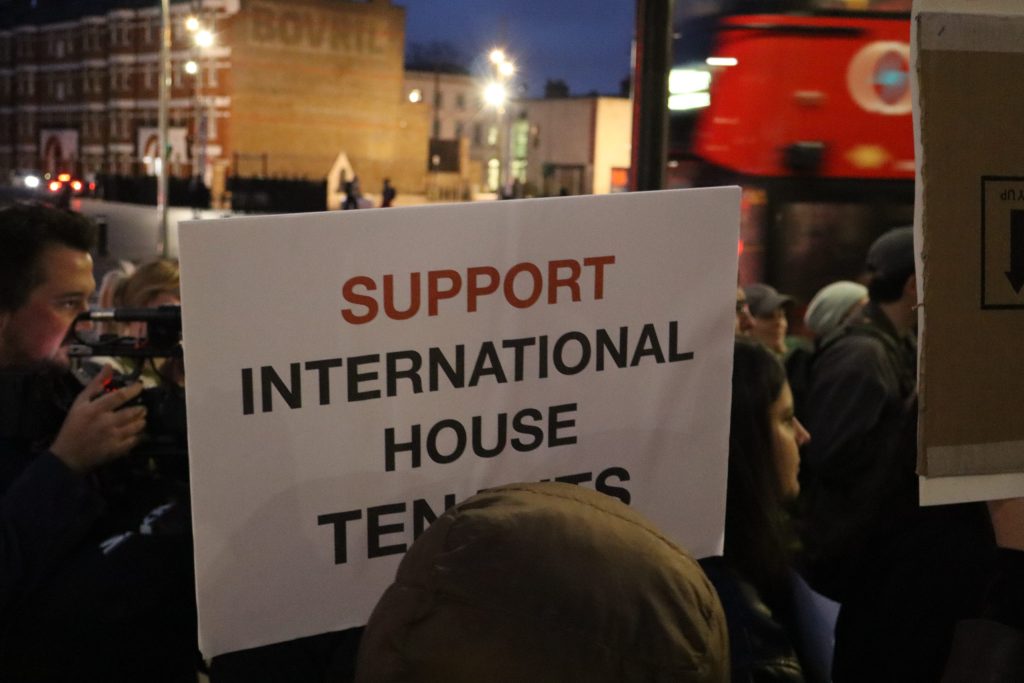 Photo at a protest with a sign that reads 'Support international house tenants'