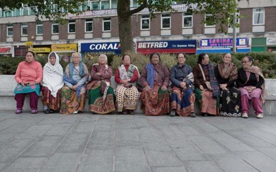 Nepali Gurkha women sitting together on a bench in Woolwich south London