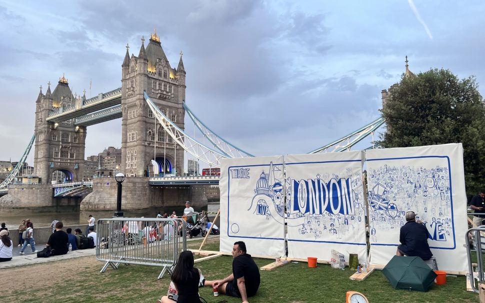 The mural being created, centred on iconography of London, in sight of Tower Bridge,