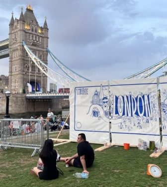 The mural being created, centred on iconography of London, in sight of Tower Bridge,