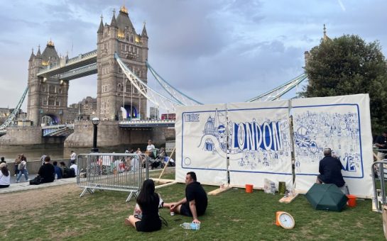 The mural being created, centred on iconography of London, in sight of Tower Bridge,