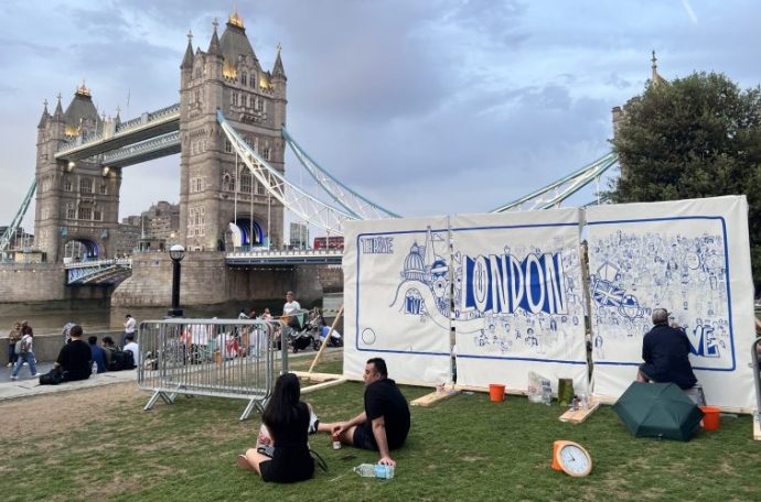 The mural being created, centred on iconography of London, in sight of Tower Bridge,