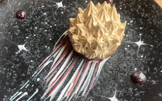 A baked Alaska dessert decorated to look like a comet from Starling Bistro