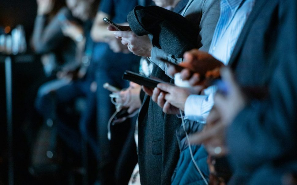 People looking at their phones (Credit: Free to use from Unsplash)