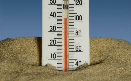 Thermometer in some sand (Credit: Free to use from Unsplash)
