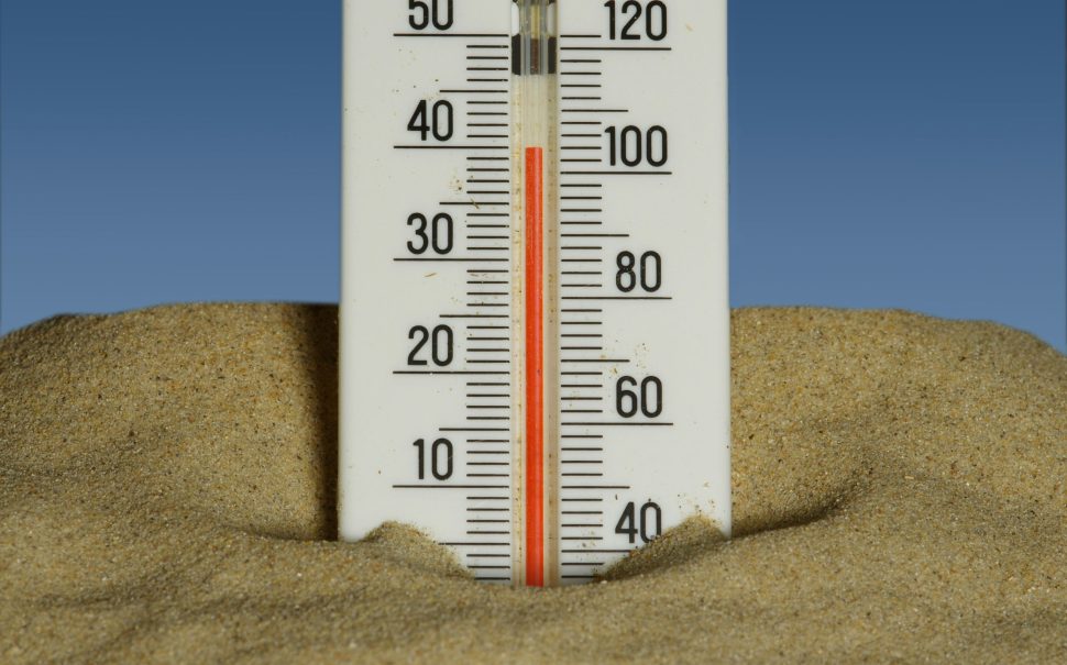 Thermometer in some sand (Credit: Free to use from Unsplash)