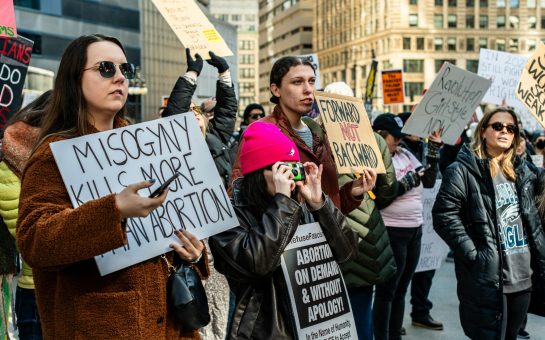 Campaigners hold up placards during a protest against misogyny