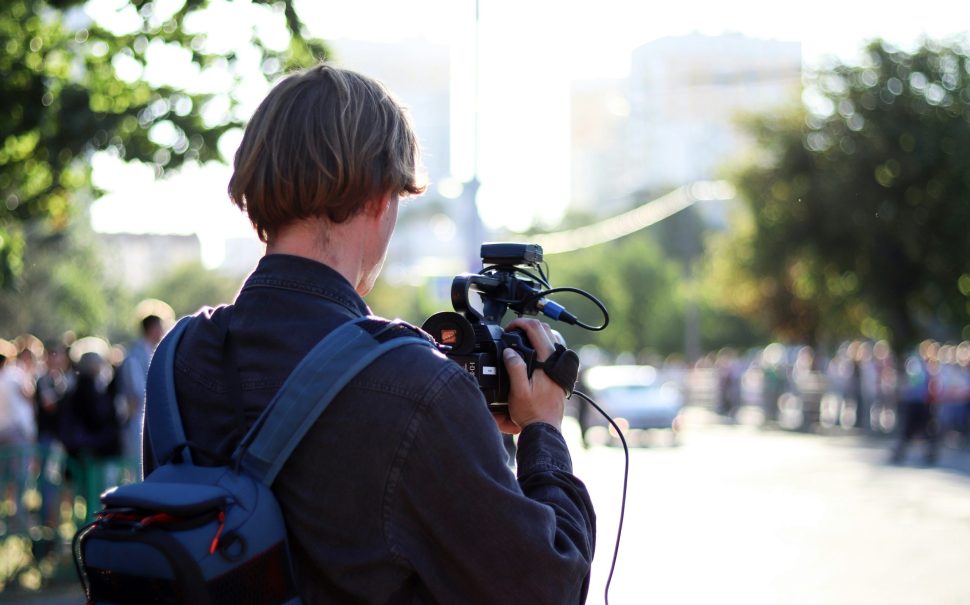 A journalist filming in the street (Credit: Free to use from Unsplash)