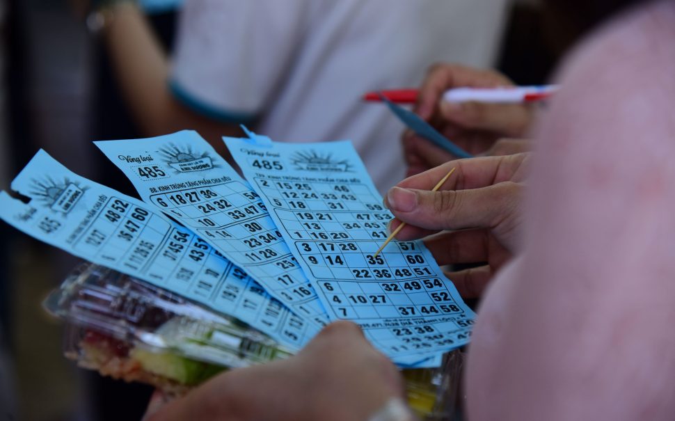 Close-up of bingo cards in a person's hand (Credit: Free to use from Pexels)