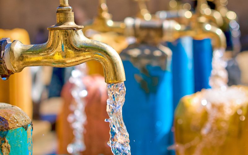 A photo of lots of taps and water coming out of them