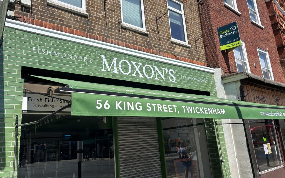 The green shopfront of Moxon's fishmongers in Twickenham.