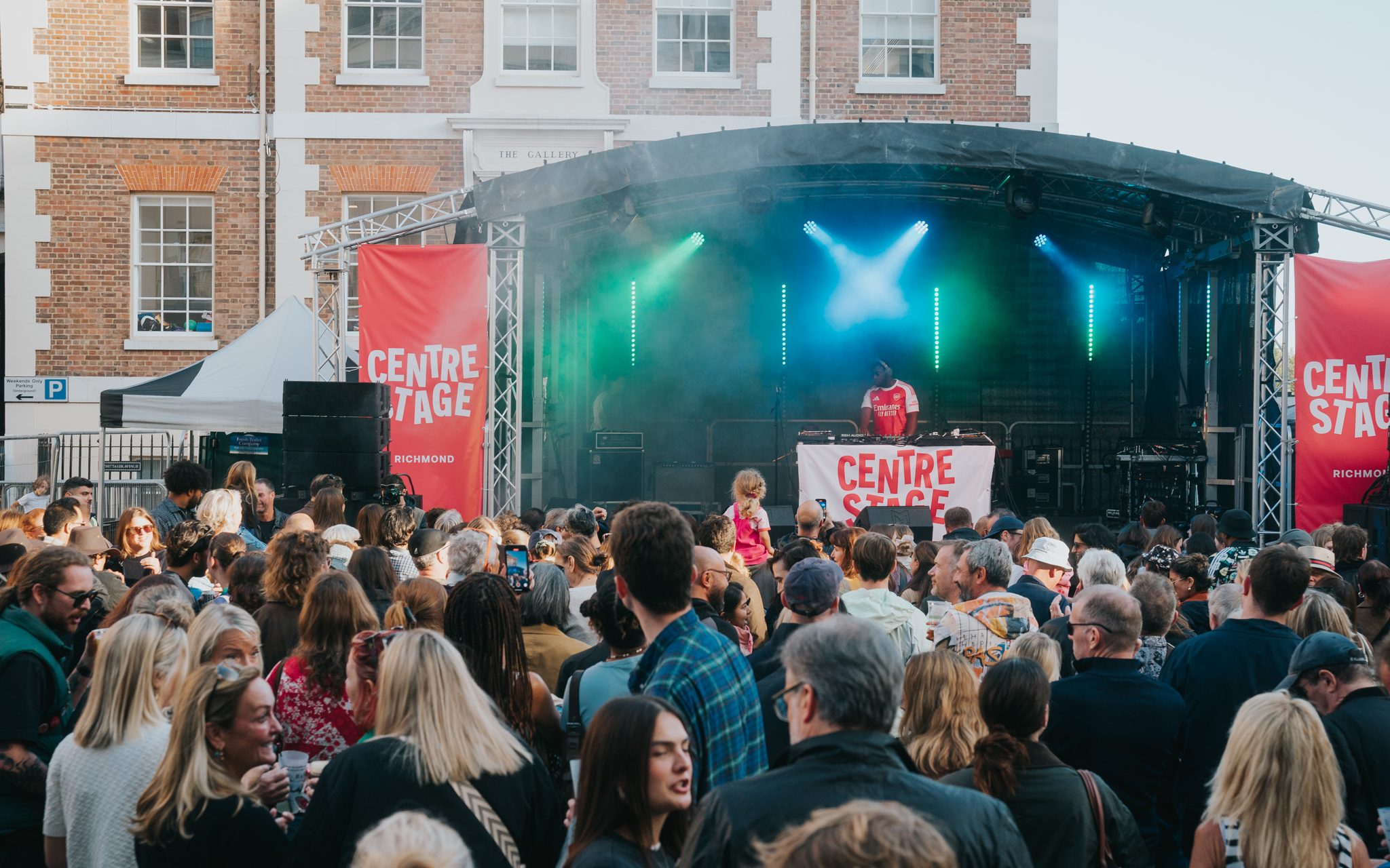 a live stage with lights is surrounded by people