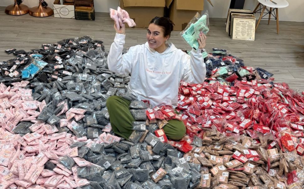 Woman sitting in pile of packages