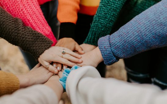 group of women holding hands