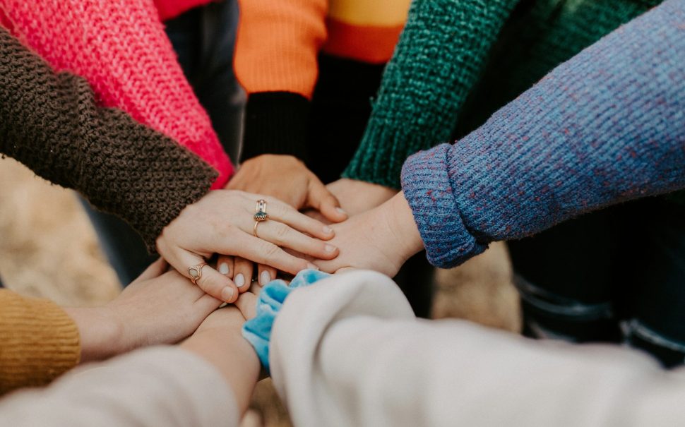 group of women holding hands