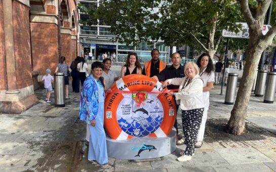 The recycling bin, in the shape of a lifebuoy, being unveiled outside St Pancras.