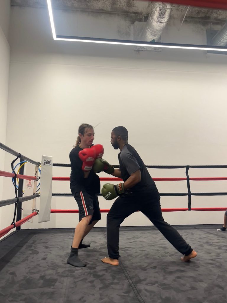 Andre Odom spars with a club member at Afewee Boxing Club.