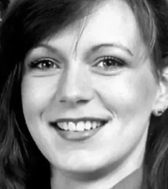 A black and white photo of a smiling Suzy Lamplugh.