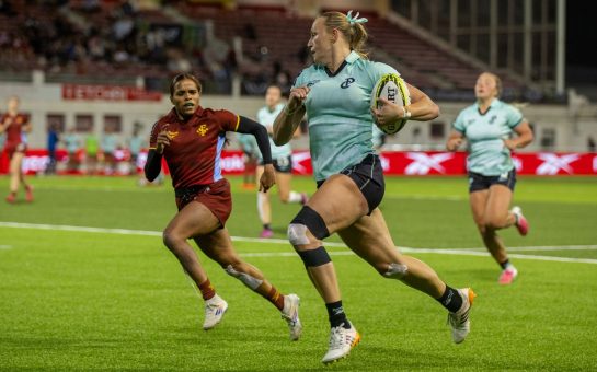 A player runs with the rugby ball