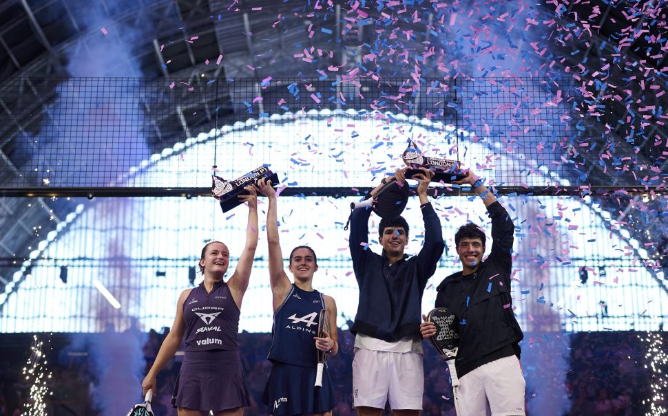 The Premier Padel men's and women's winners lift their trophies aloft.