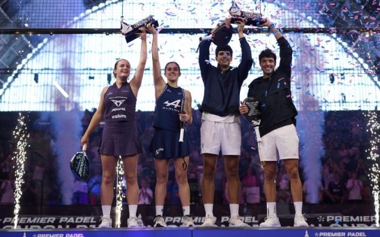 The Premier Padel men's and women's winners lift their trophies aloft.