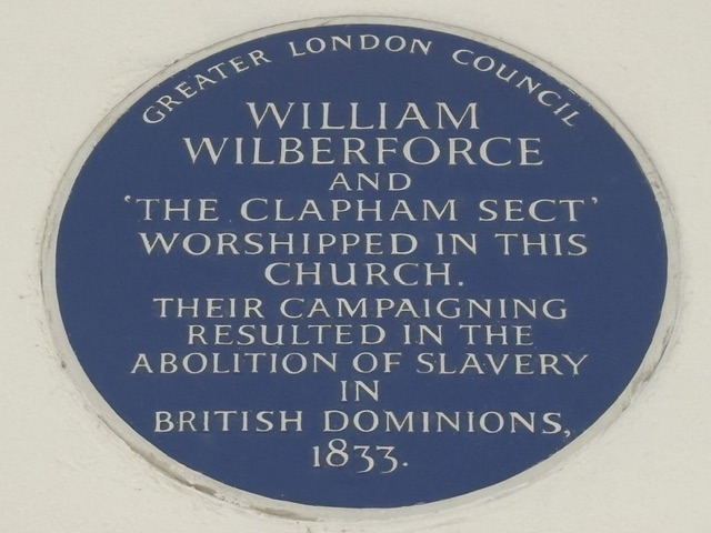 Blue Plaque outside the church reads: 'William Wilberforce and 'The Clapham Sect' worshipped in this Church. Their campaigning resulted in the Abolition of Slavery in British Dominions 1833.'