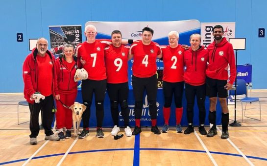 A photo of the London Elephants Goalball team in a sports hall.