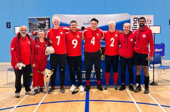 A photo of the London Elephants Goalball team in a sports hall.