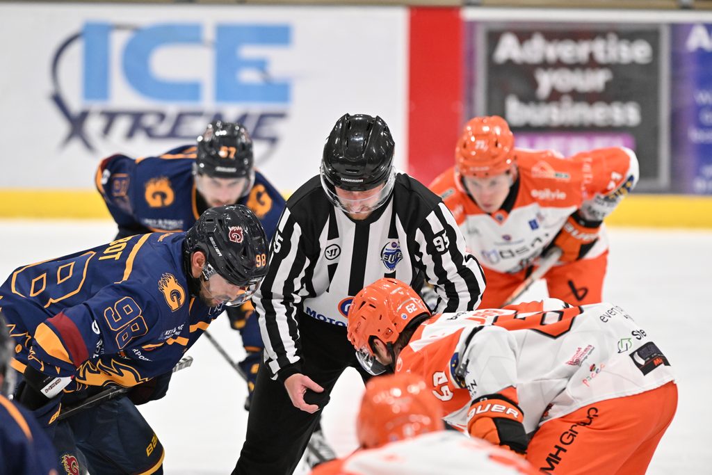 Guildford Flames players face off against Sheffield Steelers as the referee drops the puck
