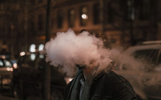 Stock image of a young person vaping