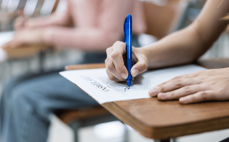 Person sitting at an exam desk (Credit: Free to use)
