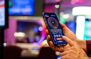 A person playing roulette on their phone (Credit: free to use from Istockphoto)