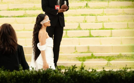 Rachel Zegler wearing a white dress