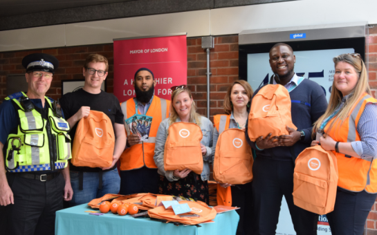 Uniformed police member and organisers with Thrive London's orange grab bags