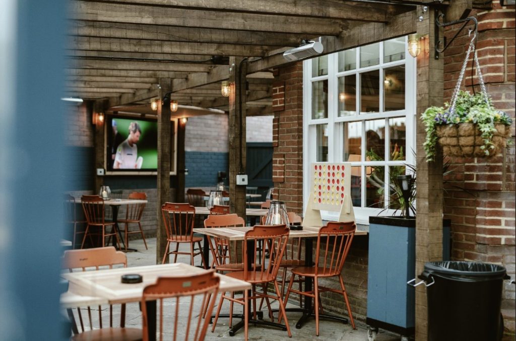A picture of the outdoor pub garden with chairs and tables