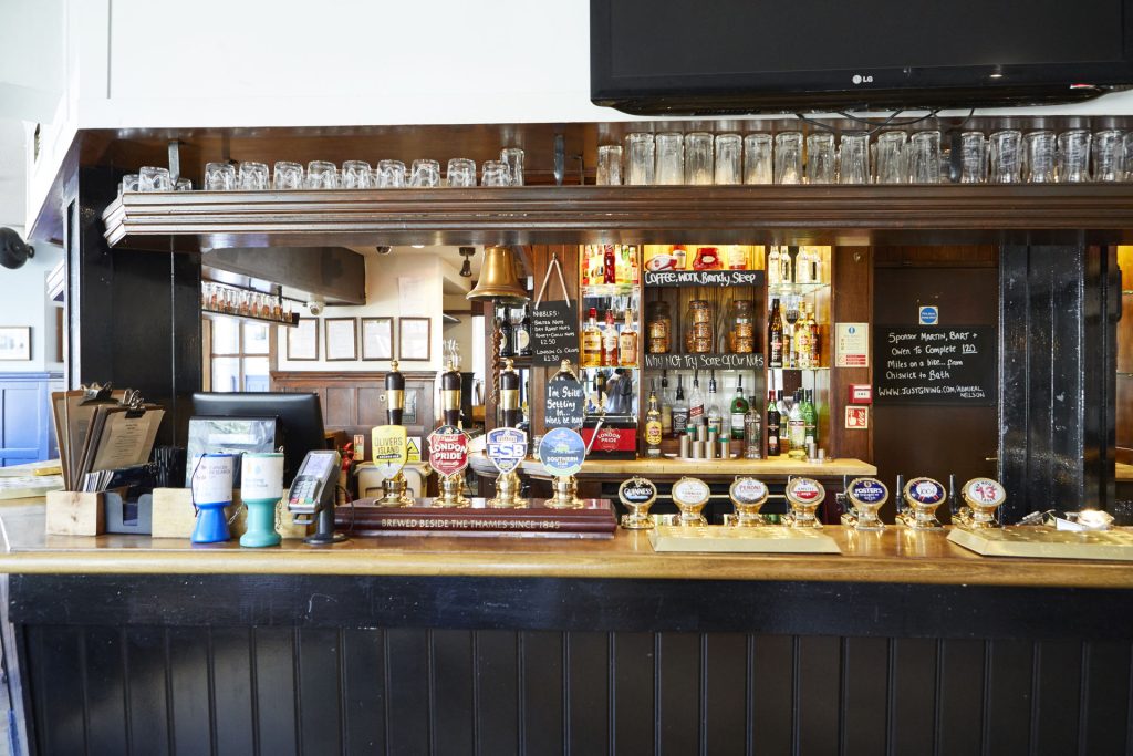 A picture of a bar with drinks and snacks