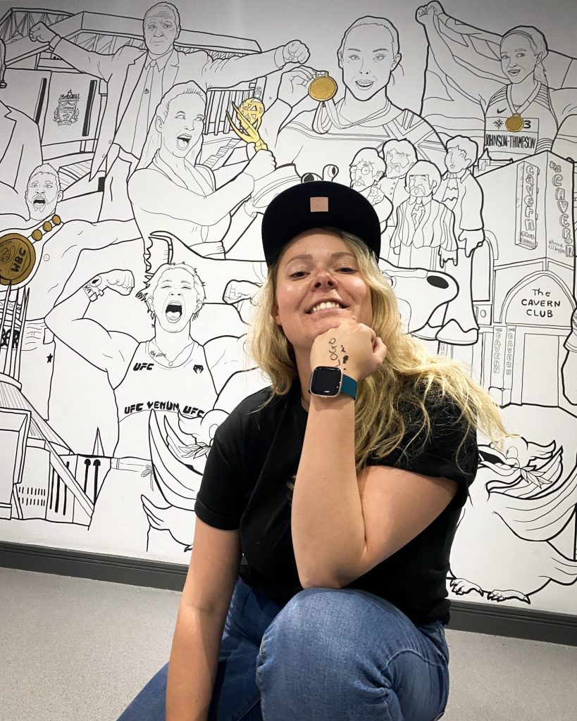 Frankie Curtis (curtiscreationz) poses with one of her sports pieces. (Image Credit: Frankie Curtis)