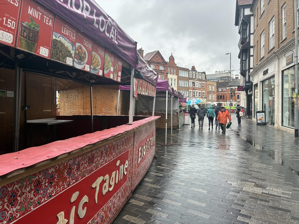 Image of the stands stretching out onto the streets in the rain 