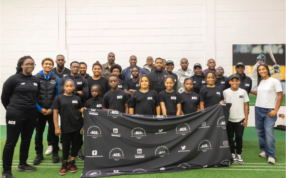 ACE Participants standing behind a banner