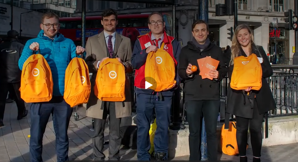Organisers holding up orange grab bags (Image: Thrive London)