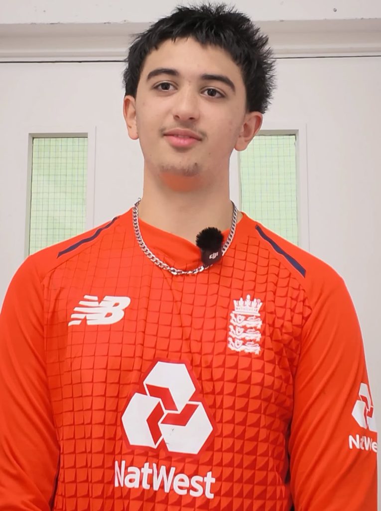Young cricketer Ismail Ramjaun in an orange training top.
