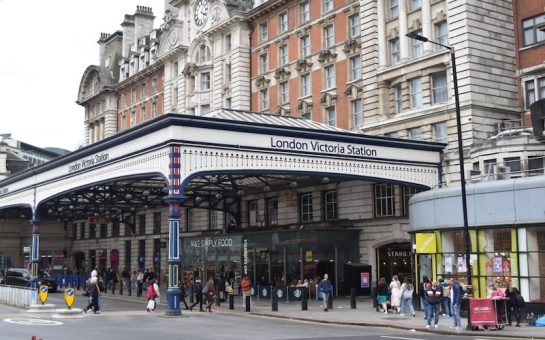 Front entrance of London Victoria station in Westminster, with pedestrians outside.
