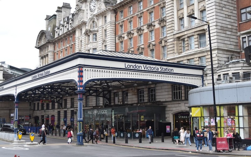 Front entrance of London Victoria station in Westminster, with pedestrians outside.