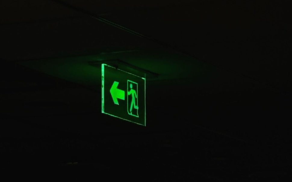 Photoluminescent fire exit sign in the dark (Picture: Free to use from Pexels)